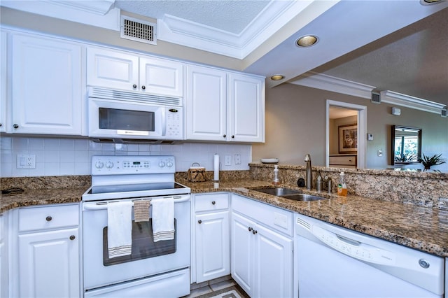 kitchen with white cabinets, sink, and white appliances