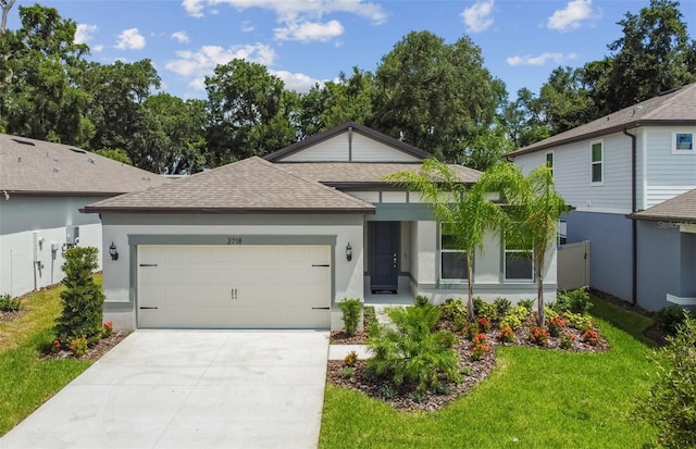 view of front of home with a front yard and a garage