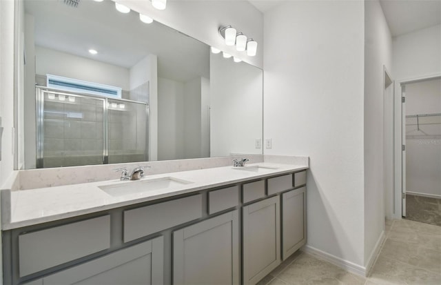 bathroom featuring vanity and a shower with shower door