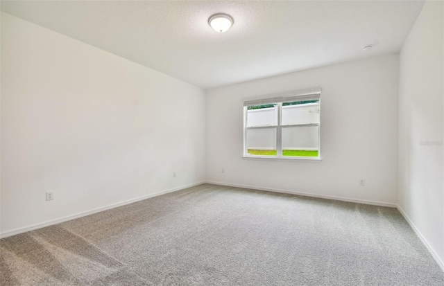 unfurnished room featuring carpet floors and a textured ceiling