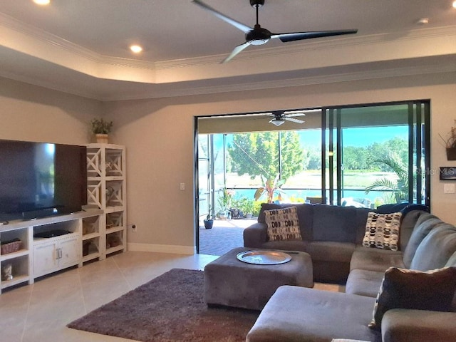 tiled living room featuring a raised ceiling, ceiling fan, and crown molding