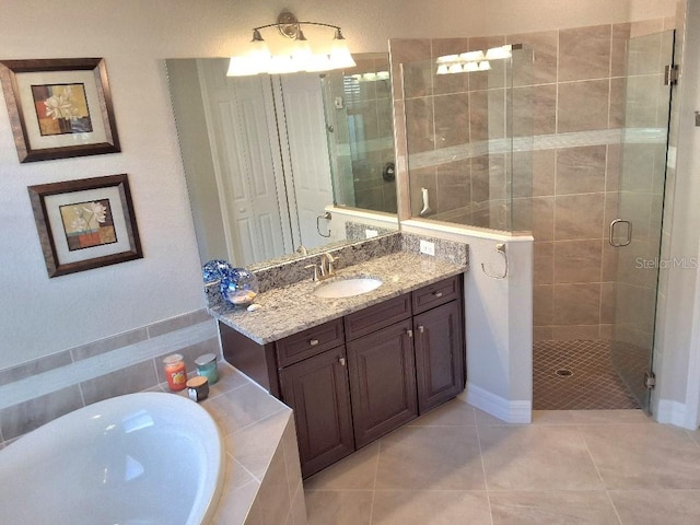 bathroom featuring shower with separate bathtub, tile floors, and vanity