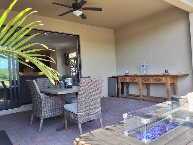 view of terrace with an outdoor bar and ceiling fan