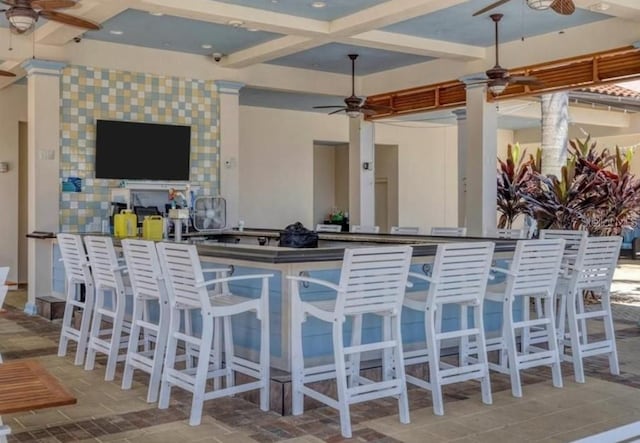 bar featuring coffered ceiling, tile flooring, and ceiling fan