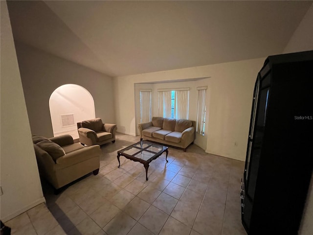 tiled living room with lofted ceiling