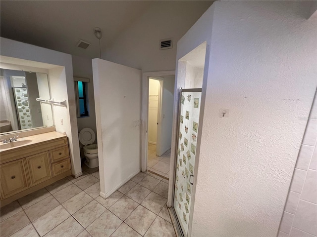 bathroom with vanity, tile floors, and toilet