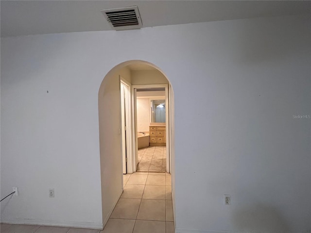 corridor featuring light tile flooring