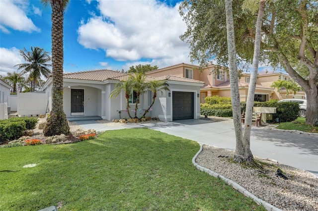 mediterranean / spanish home featuring a front yard and a garage