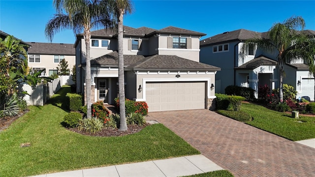 view of front of home featuring a garage and a front lawn