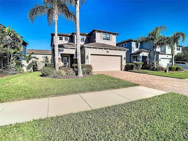 view of front of house featuring a front lawn and a garage