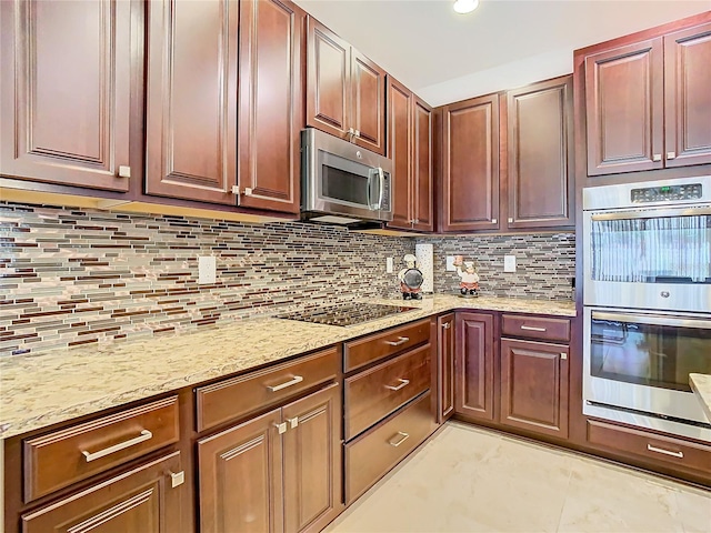 kitchen with light tile flooring, tasteful backsplash, stainless steel appliances, and light stone countertops