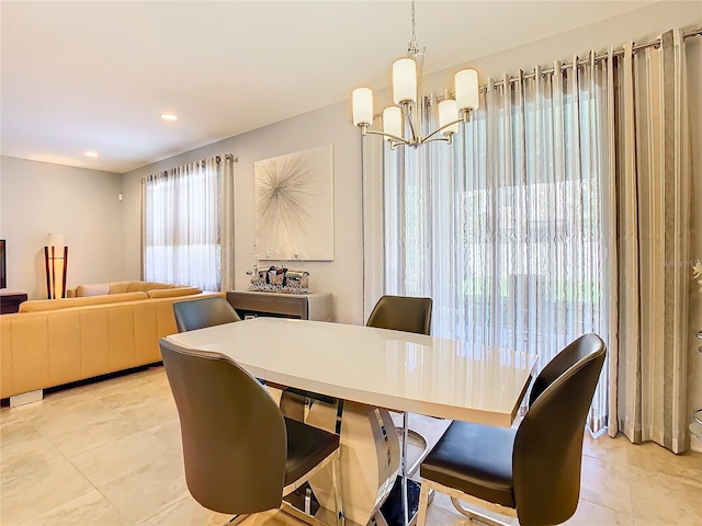 dining area with a chandelier and light tile flooring