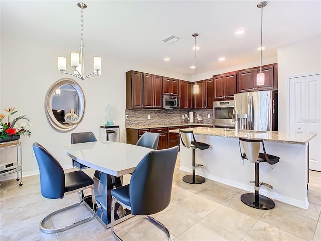 tiled dining space with an inviting chandelier