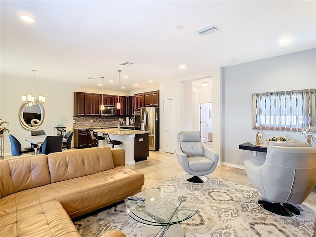 tiled living room with an inviting chandelier and sink