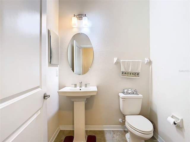 bathroom with tile floors and toilet