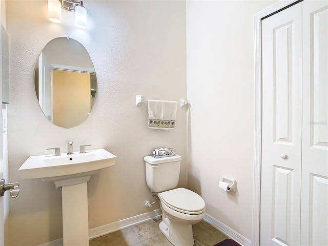 bathroom with tile floors and toilet