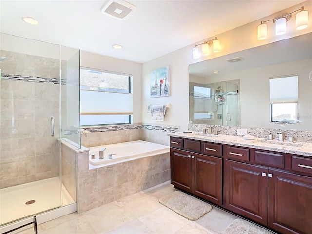 bathroom featuring tile flooring, plenty of natural light, and separate shower and tub