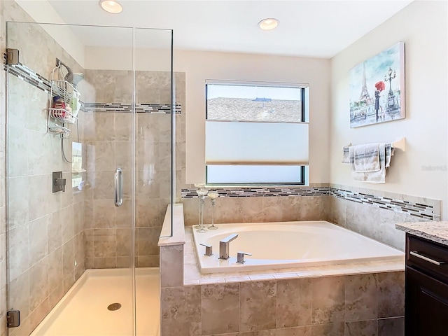 bathroom with vanity and separate shower and tub