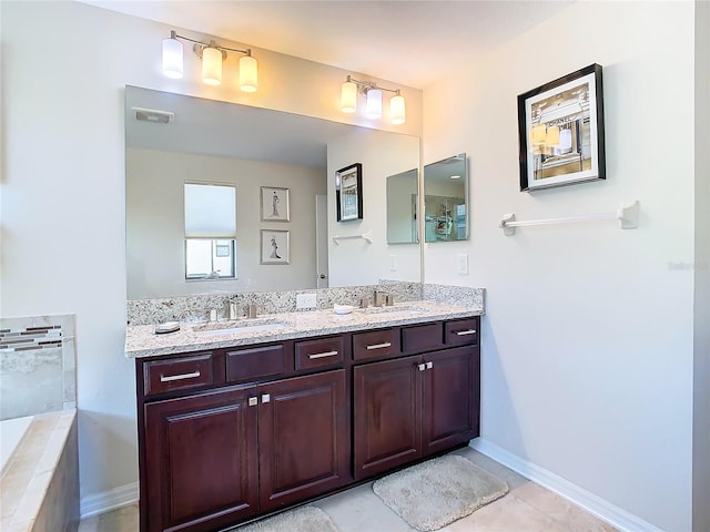 bathroom featuring tile flooring, tiled bath, double sink, and large vanity