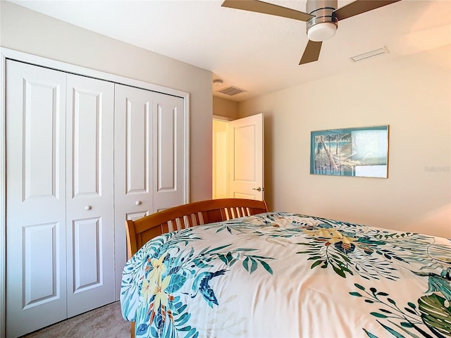 carpeted bedroom with a closet and ceiling fan