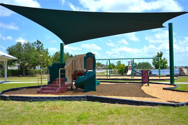 view of jungle gym featuring a lawn