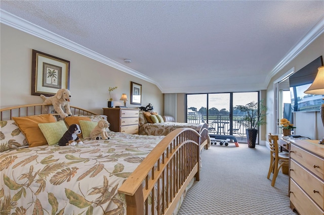 carpeted bedroom featuring ornamental molding, access to outside, and a textured ceiling