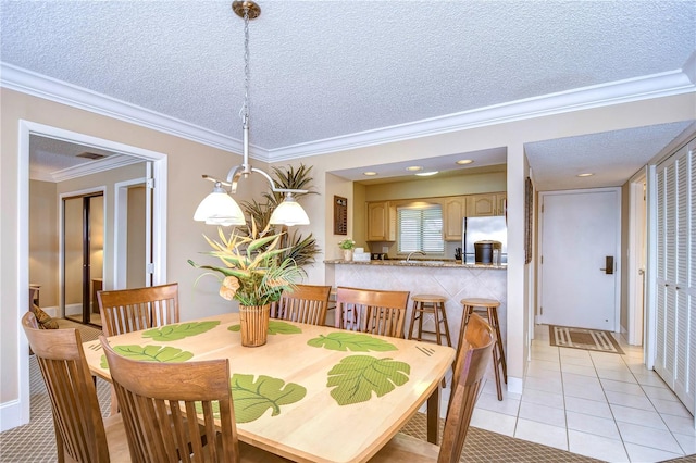 tiled dining area with crown molding and a textured ceiling