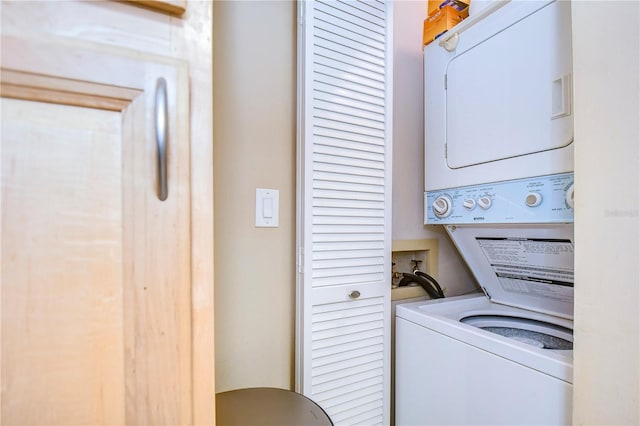 washroom with stacked washer and clothes dryer and washer hookup