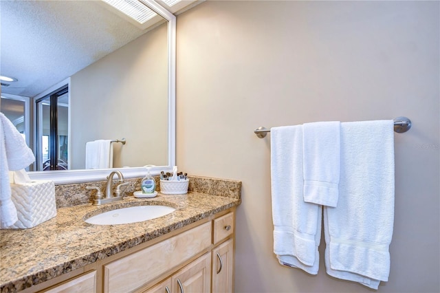 bathroom featuring vanity and a textured ceiling