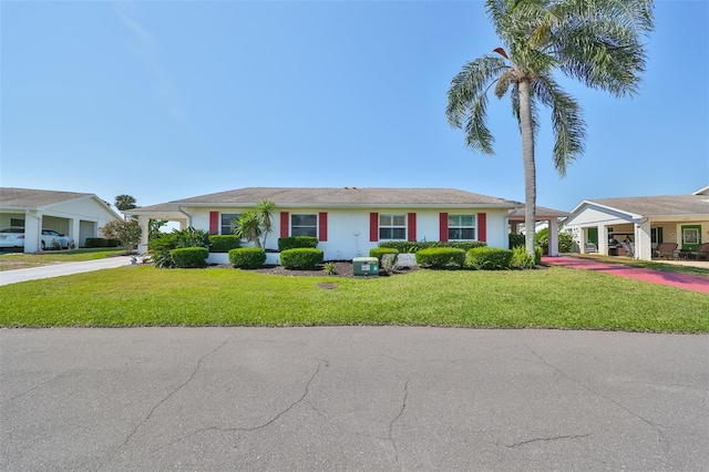 view of front of property featuring driveway, a front lawn, and stucco siding