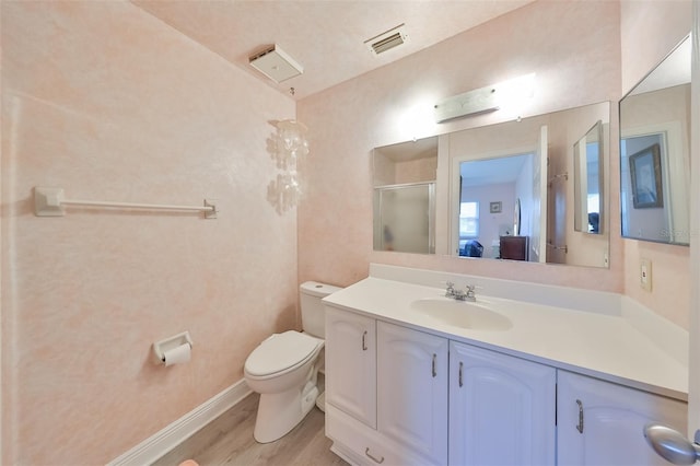 full bath featuring visible vents, toilet, vanity, wood finished floors, and baseboards