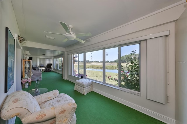 sunroom featuring a ceiling fan