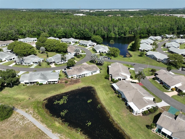 bird's eye view with a water view and a forest view