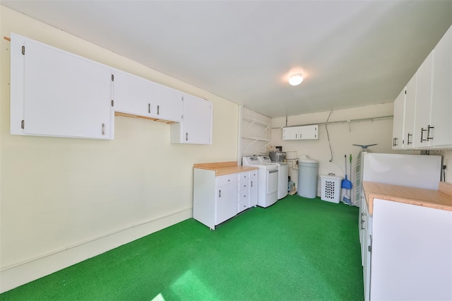 laundry area featuring laundry area, separate washer and dryer, and dark colored carpet