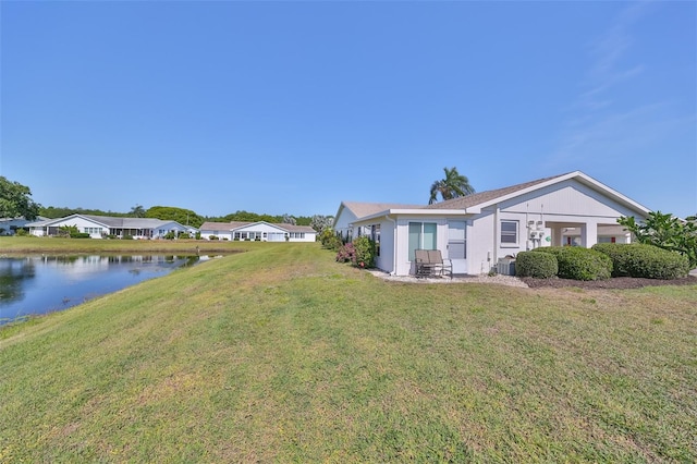 view of yard featuring central AC unit and a water view