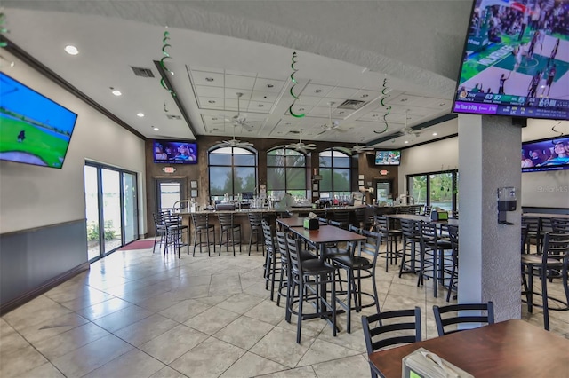 dining space featuring a healthy amount of sunlight, a towering ceiling, and visible vents