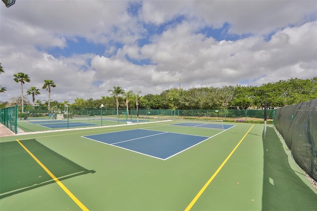 view of sport court featuring fence