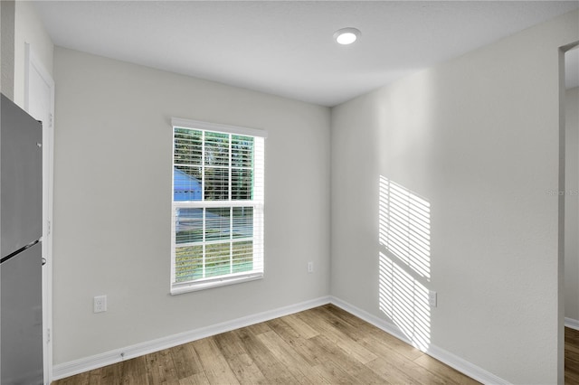 empty room with plenty of natural light and light wood-type flooring