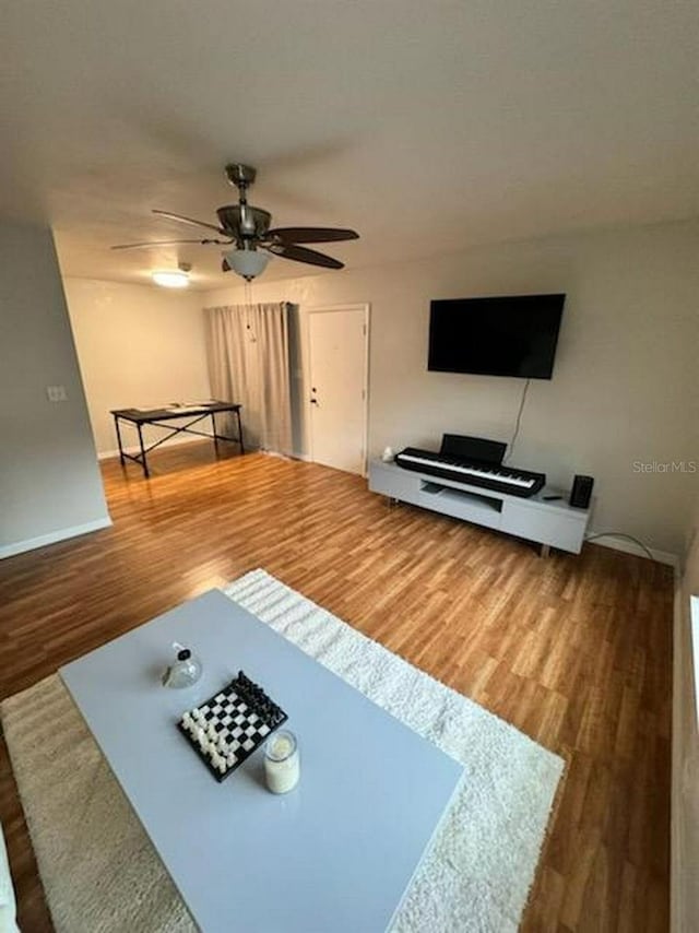 living room with ceiling fan and hardwood / wood-style floors