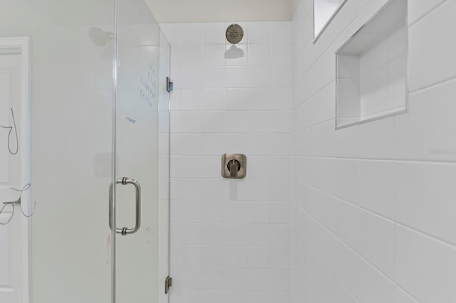 bathroom with a shower with shower door