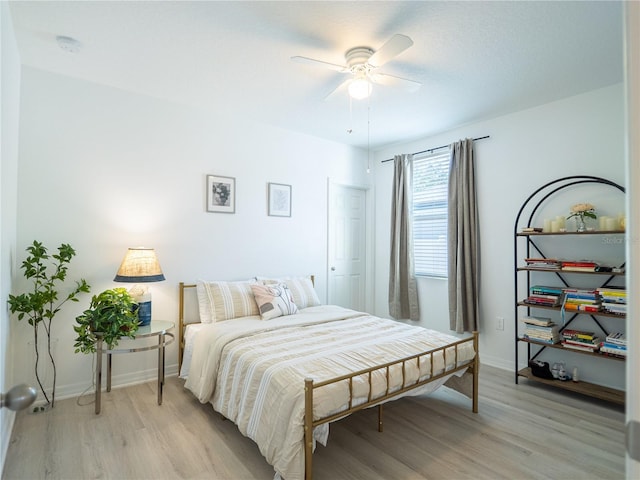 bedroom with light hardwood / wood-style flooring and ceiling fan