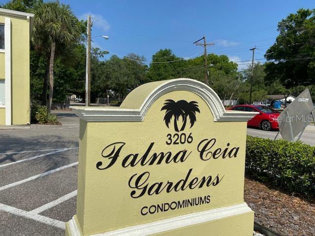 community sign featuring uncovered parking