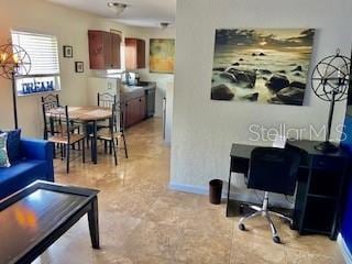 living area featuring baseboards