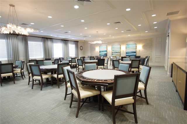 carpeted dining area featuring a chandelier and crown molding