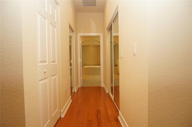 corridor featuring hardwood / wood-style flooring