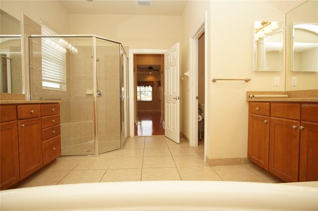 bathroom featuring tile patterned floors, vanity, and a shower with shower door