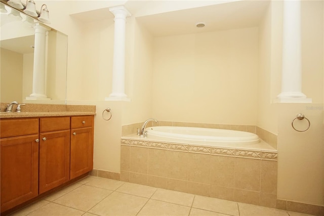 bathroom featuring tile patterned floors, vanity, and a relaxing tiled tub