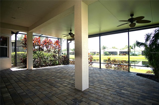 view of patio featuring ceiling fan and a water view