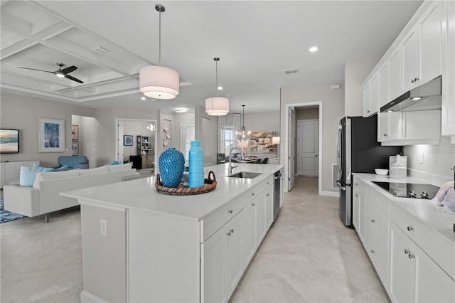 kitchen with decorative light fixtures, an island with sink, ceiling fan, and white cabinetry