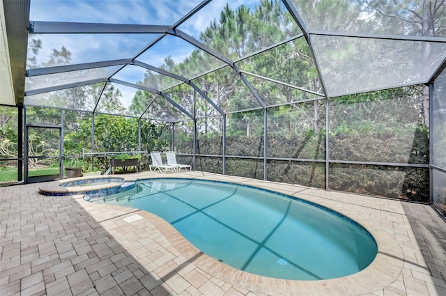 view of swimming pool with glass enclosure and a patio